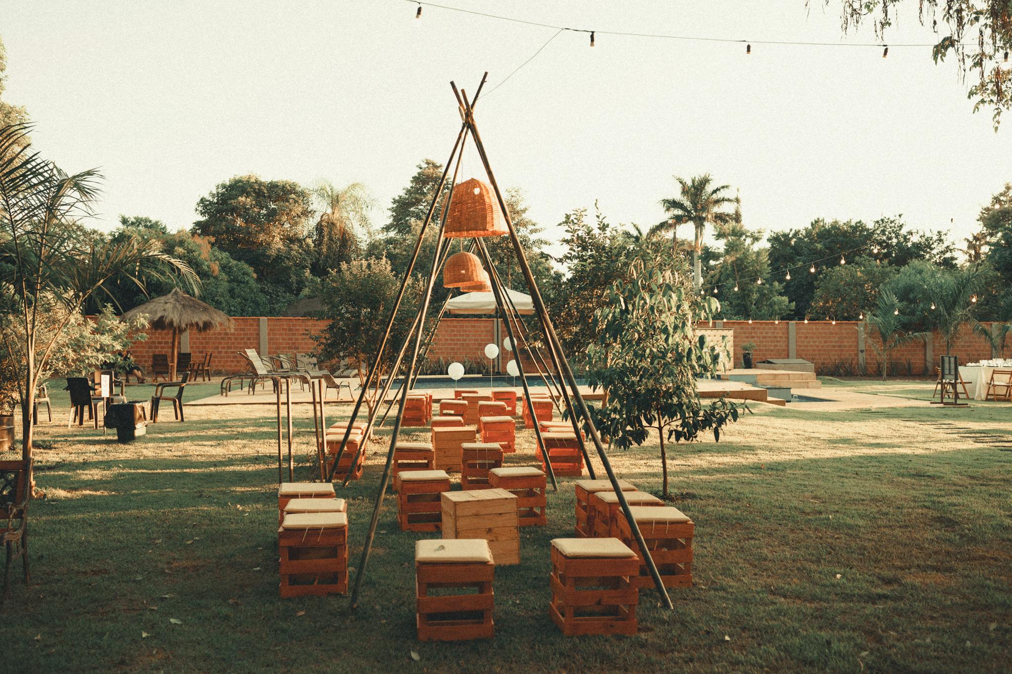 A rustic outdoor seating area in a garden setting featuring wooden crates and a green lawn.